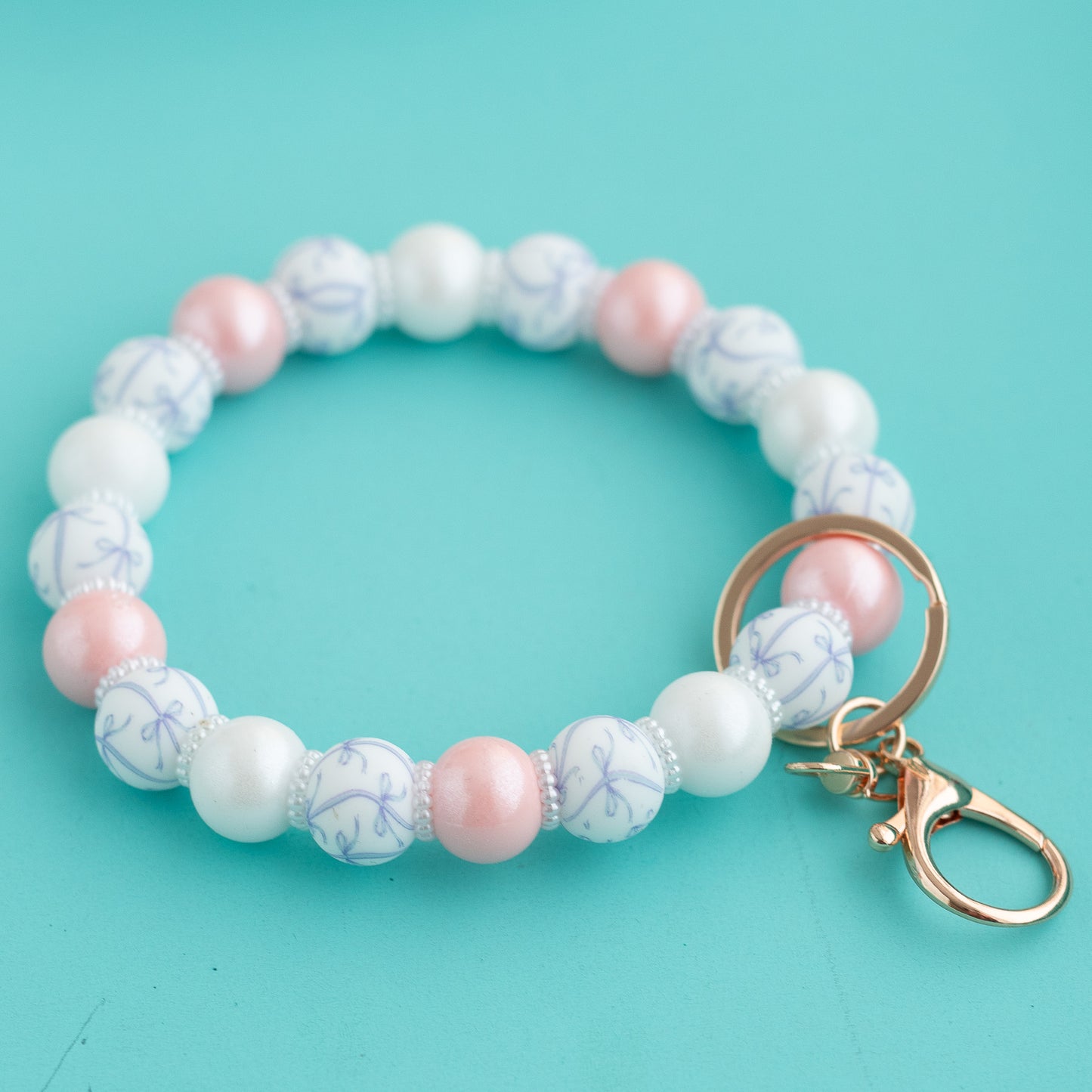 Shop the Image Bows & Pearls Wristlet silicone bead crafting from Cara & Co